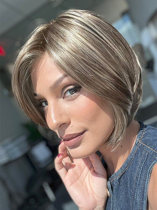 Model is wearing AVA by JON RENAU in color 10RH16 CAFFE MOCHA | Light Brown with 33% Light Natural Blonde Highlights