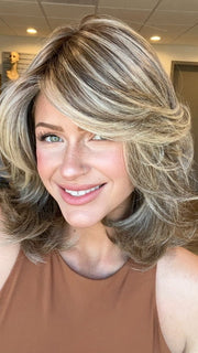 Madeline is wearing GODDESS by RAQUEL WELCH in  RL12/22SS | SHADED CAPPUCCINO | Light Golden Brown Evenly Blended with Cool Platinum Blonde Highlights and Dark Roots