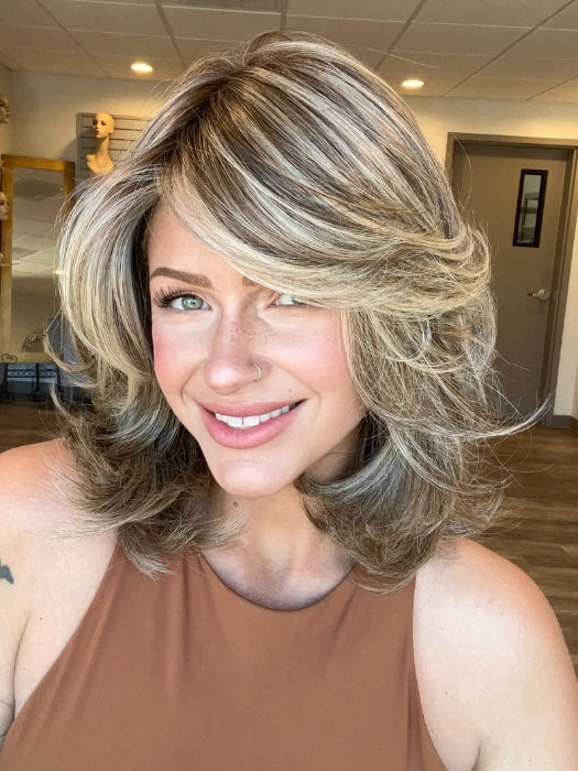 Madeline is wearing GODDESS by RAQUEL WELCH in  RL12/22SS | SHADED CAPPUCCINO | Light Golden Brown Evenly Blended with Cool Platinum Blonde Highlights and Dark Roots