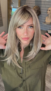 Madeline wearing CAVALLI by BELLETRESS in SPARKLING CHAMPAGNE R | Medium Ash Brown roots transition into Shimmering Champagne Blonde characterized by Pale Golden Hues with subtle Ivory and Platinum undertones reminiscent of a sparkling glass of bubbly