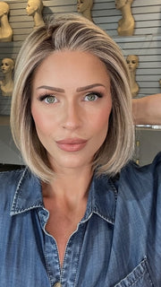 Madeline wearing BECKHAM by BELLETRESS in BUTTERCAKE BLONDE-R | A neutral-warm blonde blend featuring light brown, ash, and lightest blonde tones with natural-looking darker roots for added depth and realism.
