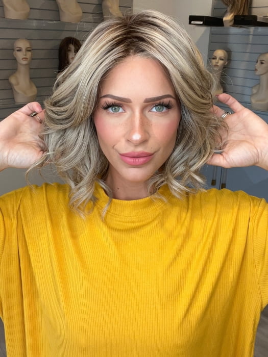 Madeline wearing ISSEY by BELLETRESS in SPARKLING CHAMPAGNE R | Medium Ash Brown roots transition into Shimmering Champagne Blonde characterized by Pale Golden Hues with subtle Ivory and Platinum undertones reminiscent of a sparkling glass of bubbly