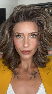 Madeline wearing KENNEDY by BELLETRESS in TRUFFLE CREAM-R | A chocolate truffle-inspired medium brown base with creamy light blonde highlights and dark roots, creating a balanced, multidimensional brunette.