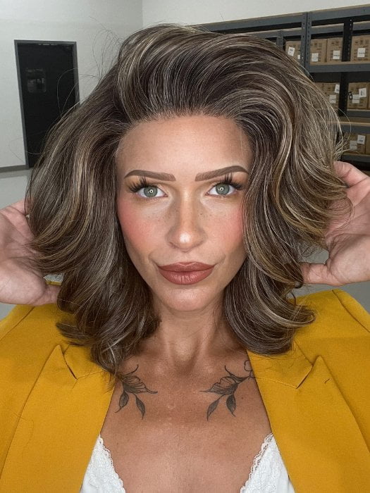 Madeline wearing KENNEDY by BELLETRESS in TRUFFLE CREAM-R | A chocolate truffle-inspired medium brown base with creamy light blonde highlights and dark roots, creating a balanced, multidimensional brunette.