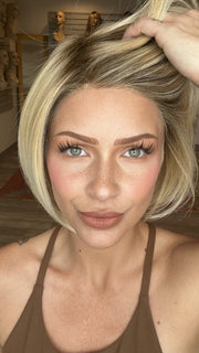 Madeline is wearing SMOOTH CUT BOB by TRESSALLURE in 24/102/R12 | Gold Blonde with Platinum Highlights with Gold Brown Roots