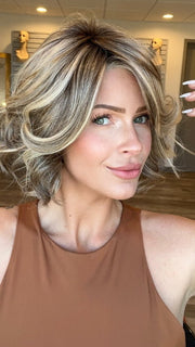 Madeline is wearing FLIRT ALERT by RAQUEL WELCH in RL12/22SS SHADED CAPPUCCINO | Light Golden Brown Evenly Blended with Cool Platinum Blonde Highlights with Dark Roots