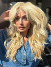 Roxie is wearing California Beach Waves by TressAllure in shade 223/23C | Light Golden Blonde