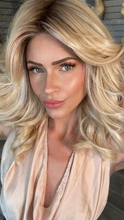 Madeline wearing MILLION DOLLAR BABE by TRESSALLURE in 24/102/R12 | Gold Blonde with Platinum Highlights with Gold Brown Roots