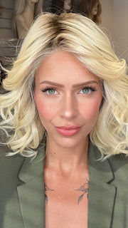 Madeline wearing EDITOR'S PICK ELITE by RAQUEL WELCH in RL613SS SHADED PLATINUM | Dark Brown roots with Warm Platinum Blonde
