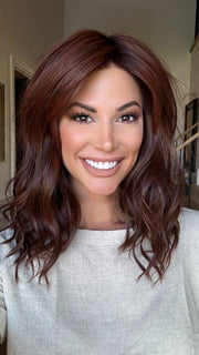 Katy C. @thewigeducator wearing BEACH WAVE MAGIC by TRESSALLURE in color 10/130R | Bright Red with Medium Brown roots