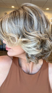 Madeline is wearing FLIRT ALERT by RAQUEL WELCH in RL12/22SS SHADED CAPPUCCINO | Light Golden Brown Evenly Blended with Cool Platinum Blonde Highlights with Dark Roots
