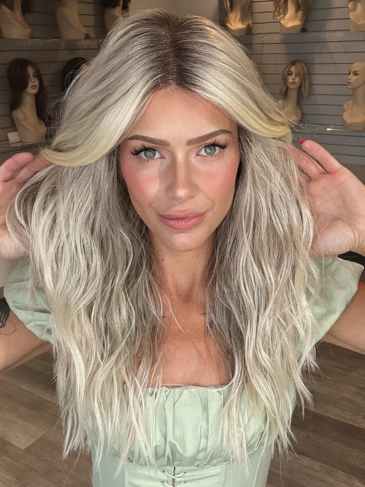 Madeline is wearing ROXIE by RENE OF PARIS in shade BILLIONAIRE-BLOND | A chic, sophisticated shade with a rich mocha root melting into beige, ash, and cream blond tones. Face-framing cream and white blond highlights add a refined, upscale finish.