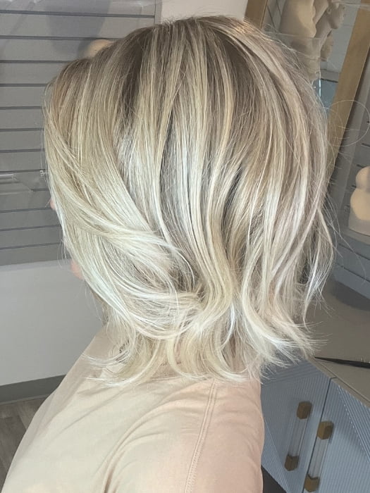 Madeline wearing FARREN by AMORE in MELTED-SAND | Rich, warm brown root melts into the neutral blond tone. Light-beige blond ends complete this stunning color.