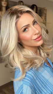 Madeline wearing AMANDA by ENVY in PLATINUM SHADOW | Light Blonde with Dark Roots