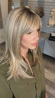 Madeline wearing CAVALLI by BELLETRESS in SPARKLING CHAMPAGNE R | Medium Ash Brown roots transition into Shimmering Champagne Blonde characterized by Pale Golden Hues with subtle Ivory and Platinum undertones reminiscent of a sparkling glass of bubbly