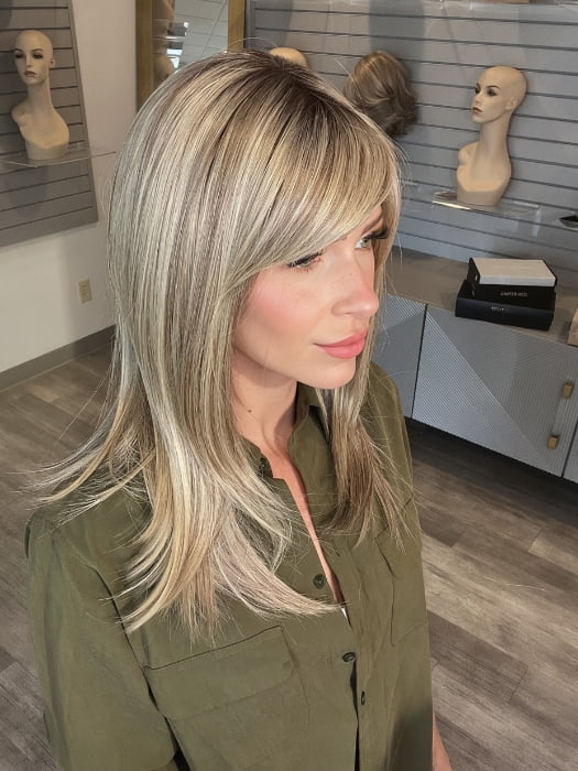 Madeline wearing CAVALLI by BELLETRESS in SPARKLING CHAMPAGNE R | Medium Ash Brown roots transition into Shimmering Champagne Blonde characterized by Pale Golden Hues with subtle Ivory and Platinum undertones reminiscent of a sparkling glass of bubbly