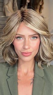 Madeline wearing EDITOR'S PICK ELITE by RAQUEL WELCH in RL12/22SS SHADED CAPPUCCINO | Light Golden Brown Evenly Blended with Cool Platinum Blonde Highlights with Dark Roots