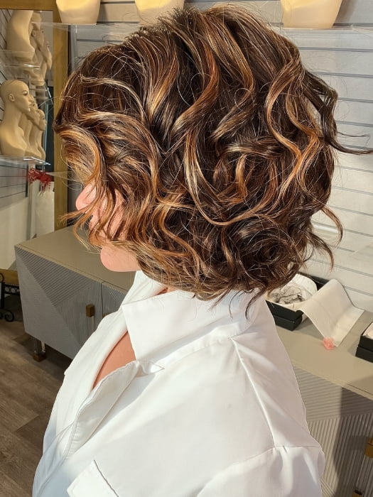 Madeline wearing HOUSTON by BELLETRESS in FRENCH ROAST BROWN-R  | A deep, luxurious brunette featuring a dark brown base with warm bronze and subtle red undertones. Softly rooted for natural depth and dimension.