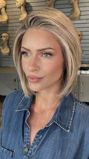 Madeline wearing BECKHAM by BELLETRESS in BUTTERCAKE BLONDE-R | A neutral-warm blonde blend featuring light brown, ash, and lightest blonde tones with natural-looking darker roots for added depth and realism.