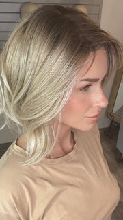 Madeline wearing FARREN by AMORE in MELTED-SAND | Rich, warm brown root melts into the neutral blond tone. Light-beige blond ends complete this stunning color.