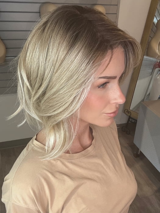 Madeline wearing FARREN by AMORE in MELTED-SAND | Rich, warm brown root melts into the neutral blond tone. Light-beige blond ends complete this stunning color.