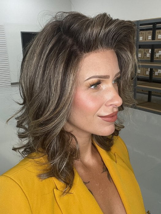 Madeline wearing KENNEDY by BELLETRESS in TRUFFLE CREAM-R | A chocolate truffle-inspired medium brown base with creamy light blonde highlights and dark roots, creating a balanced, multidimensional brunette.