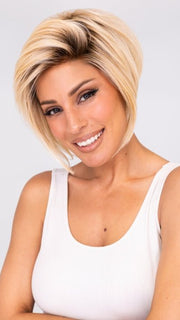 Model is wearing IGNITE by JON RENAU in color FS24/102S12 LAGUNA BLONDE | Light Natural Gold Blonde with Pale Natural Gold Blonde bold highlights, Shaded with Light Gold Brown