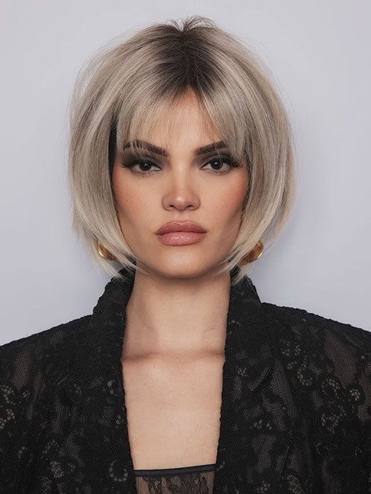 Model is wearing ARIA by RENE OF PARIS in color BILLIONAIRE BLOND | A chic, sophisticated shade with a rich mocha root melting into beige, ash, and cream blond tones. Face-framing cream and white blond highlights add a refined, upscale finish.