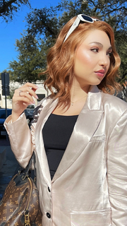 Maha wearing SIMMER ELITE PETITE by RAQUEL WELCH WIGS in color RL29/33SS ICED PUMPKIN SPICE | Strawberry Blonde Shaded with Dark Red-Brown