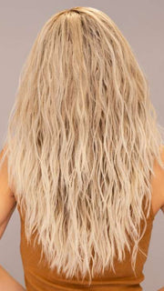 Model is wearing ROXIE by RENE OF PARIS in shade BILLIONAIRE-BLOND | A chic, sophisticated shade with a rich mocha root melting into beige, ash, and cream blond tones. Face-framing cream and white blond highlights add a refined, upscale finish.