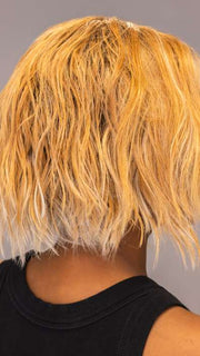 Model is wearing ROSANNA by RENE OF PARIS in shade PEACHES-AND-CREAM | A vibrant peach blonde with creamy undertones and bright, face-framing cream highlights. Rich chocolate root adds depth.