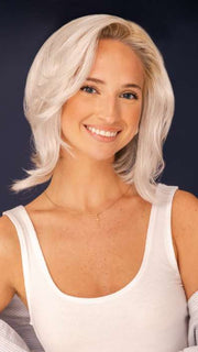 Model is wearing SHEENA by RENE OF PARIS in color GHOST-BLONDE-R | Medium neutral blond roots fade into a pearl cream blond shade with platinum blond undertones.