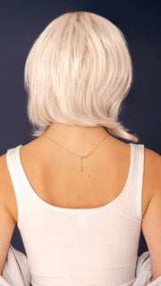 Model is wearing SHEENA by RENE OF PARIS in color GHOST-BLONDE-R | Medium neutral blond roots fade into a pearl cream blond shade with platinum blond undertones.