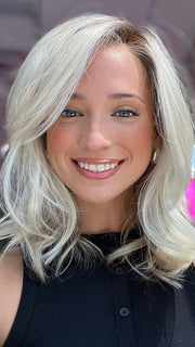 Model is wearing DAZZLING WAVEZ by RENE OF PARIS in color MILKY OPAL R | A Blend of Creamy Blonde and White Blonde Rooted with Warm Brown