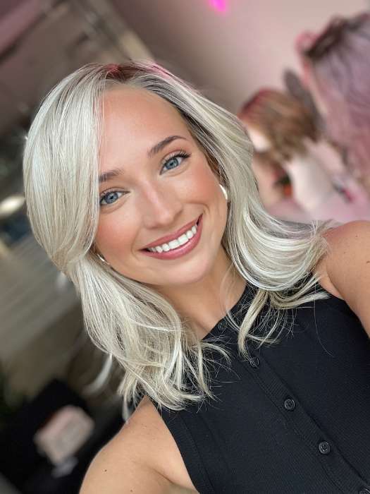 Model is wearing DAZZLING WAVEZ by RENE OF PARIS in color MILKY OPAL R | A Blend of Creamy Blonde and White Blonde Rooted with Warm Brown