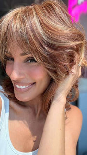 Model is wearing ON MY WAY by RAQUEL WELCH in color RL31/29 FIERY COPPER | Medium Light Auburn Evenly Blended with Ginger Blonde