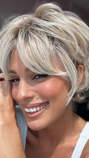 Model is wearing CURATED CUT by RAQUEL WELCH in color RL19/23SS SHADED BISCUIT | Light Ash Blonde Evenly Blended with Cool Platinum Blonde with Dark Roots
