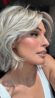 Model is wearing MAIN CHARACTER by RAQUEL WELCH in color RL17/23SS ICED LATTE MACCHIATO | Honey Blonde shaded with Cool Blonde and Dark Roots
