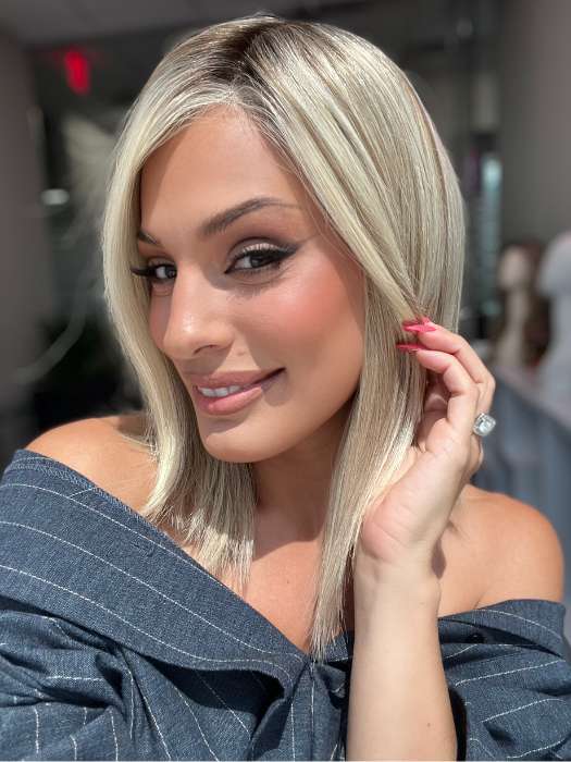 Model is wearing CARRIE by JON RENAU in color 101/88/27S8 CATALINA BLONDE | Pale blonde with Pure White Natural Violet halo highlights, shaded medium brown