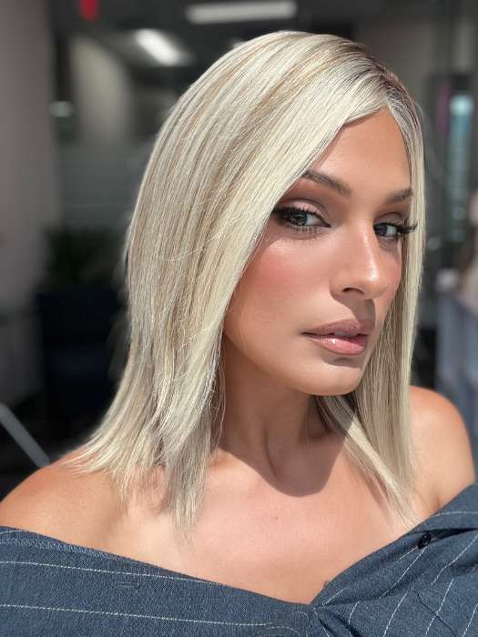 Model is wearing CARRIE by JON RENAU in color 101/88/27S8 CATALINA BLONDE | Pale blonde with Pure White Natural Violet halo highlights, shaded medium brown