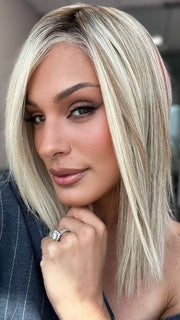 Model is wearing CARRIE LARGE by JON RENAU in color 101/88/27S8 CATALINA BLONDE | Pale blonde with Pure White Natural Violet halo highlights, shaded medium brown