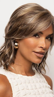 A cute medium bob with soft waves and side-swept bangs