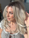 Roxie wearing BROOKLYN by BELLE TRESS in color MILKSHAKE BLONDE R | Mixture of Light sandy brown, highlighted with light ash blonde with a hint of light platinum blonde with medium root color.
