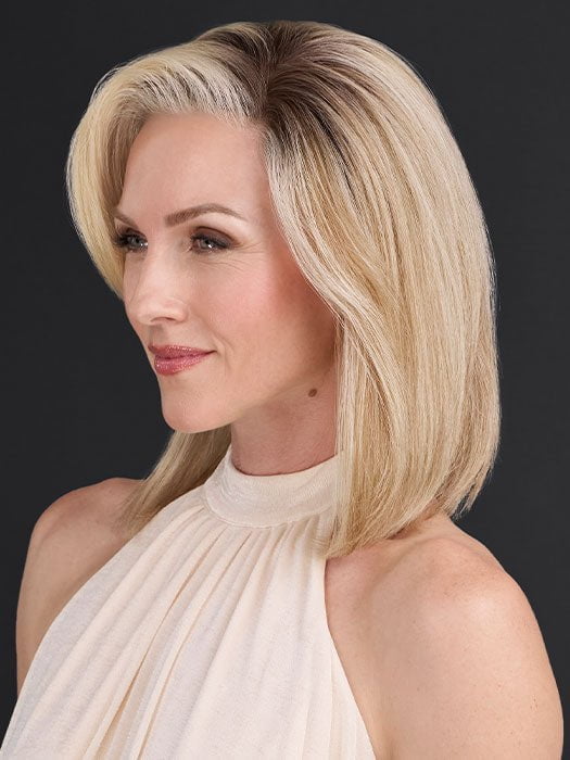 Model is wearing CARRIE by JON RENAU in color 101/88/27S8 CATALINA BLONDE | Pale blonde with Pure White Natural Violet halo highlights, shaded medium brown