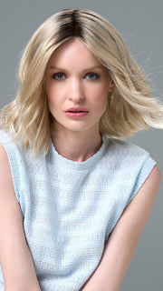 Model is wearing Charlotte Petite by ENVY in color SILKY BEIGE |  Light Platinum Blonde with Dark Brown Roots
