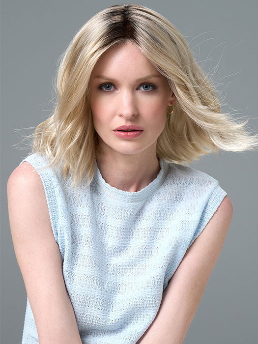 Model is wearing Charlotte Large by ENVY in color SILKY BEIGE |  Light Platinum Blonde with Dark Brown Roots