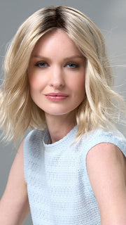 Model is wearing Charlotte Petite by ENVY in color SILKY BEIGE |  Light Platinum Blonde with Dark Brown Roots