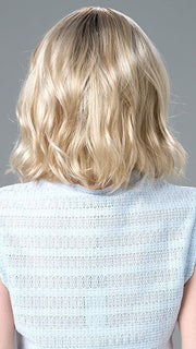 Model is wearing Charlotte Petite by ENVY in color SILKY BEIGE |  Light Platinum Blonde with Dark Brown Roots