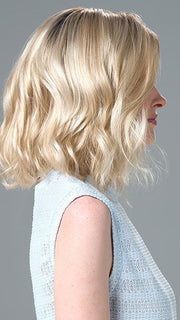 Model is wearing Charlotte Large by ENVY in color SILKY BEIGE |  Light Platinum Blonde with Dark Brown Roots