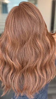 Model is wearing DECADENT DIVA by RAQUEL WELCH in shade RL32/31 CINNABAR | Medium Dark Auburn Evenly Blended with Medium Light Auburn